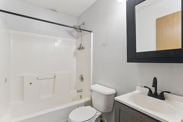 bathroom featuring toilet, shower / tub combination, vanity, and a textured ceiling