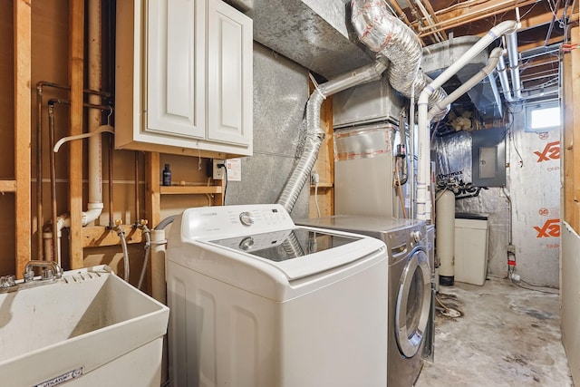 laundry area with washer and dryer, electric panel, and a sink