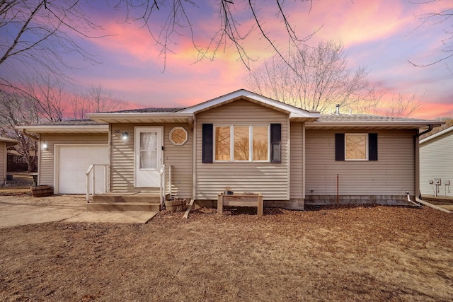 single story home featuring an attached garage and concrete driveway