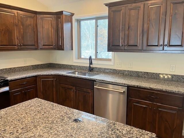 kitchen featuring dishwasher, dark brown cabinets, stone countertops, and a sink