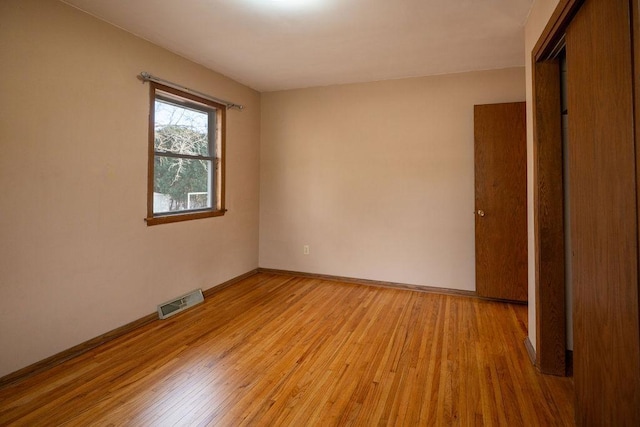 unfurnished bedroom with visible vents, baseboards, and light wood-style flooring