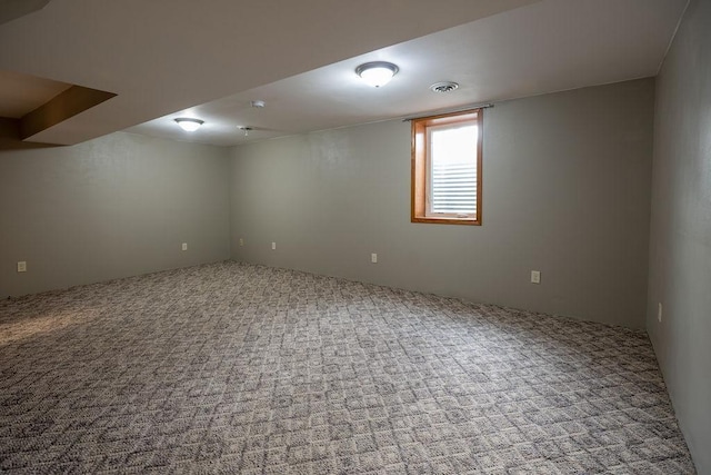 basement with visible vents and carpet