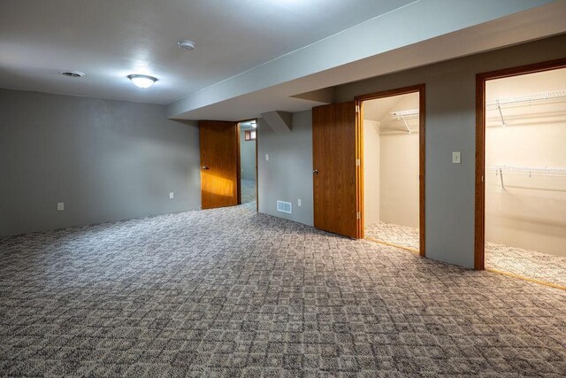 finished basement featuring carpet flooring and visible vents