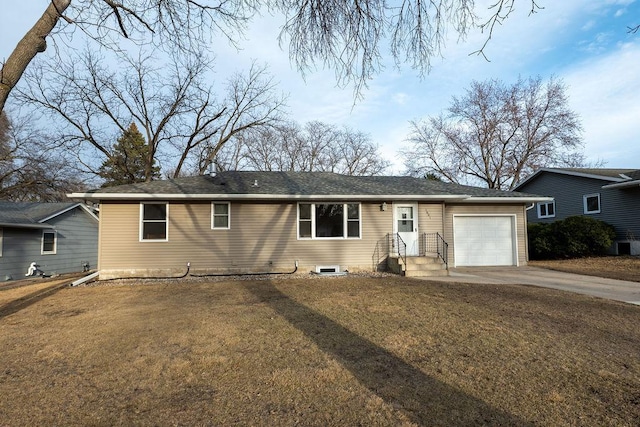 ranch-style house featuring concrete driveway, a garage, and a front lawn