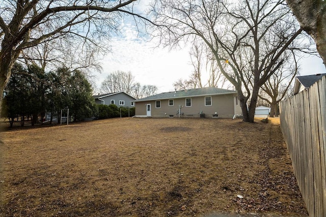 back of house with fence and crawl space