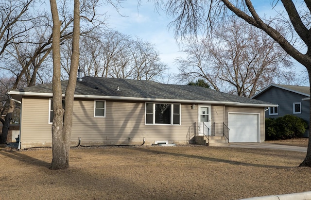 ranch-style house featuring an attached garage and a shingled roof