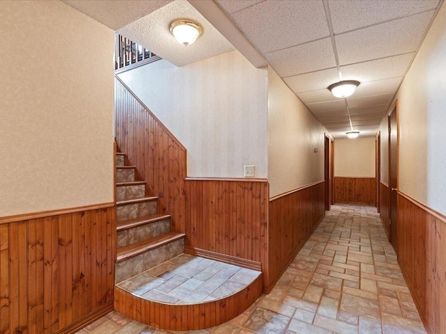 9529- 20th St, Saint Mathias Twp, MN 56449 - hallway with wooden walls, a wainscoted wall, brick floor, and stairs