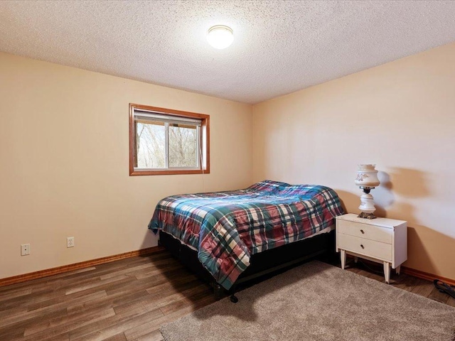 9529- 20th St, Saint Mathias Twp, MN 56449 - bedroom with baseboards, wood finished floors, and a textured ceiling