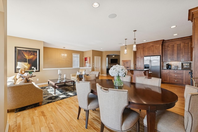 dining room featuring recessed lighting, a chandelier, and light wood finished floors