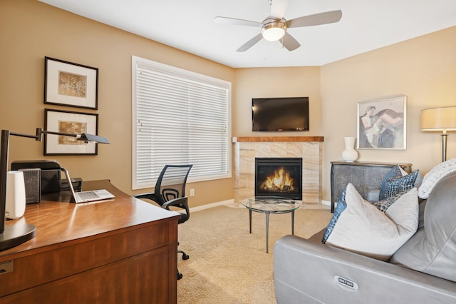 carpeted office with baseboards, a tile fireplace, and ceiling fan