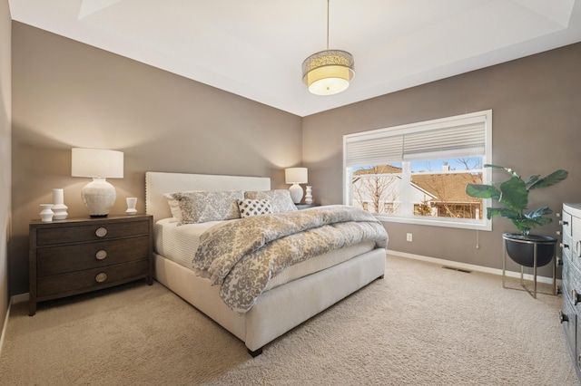 carpeted bedroom with baseboards and visible vents