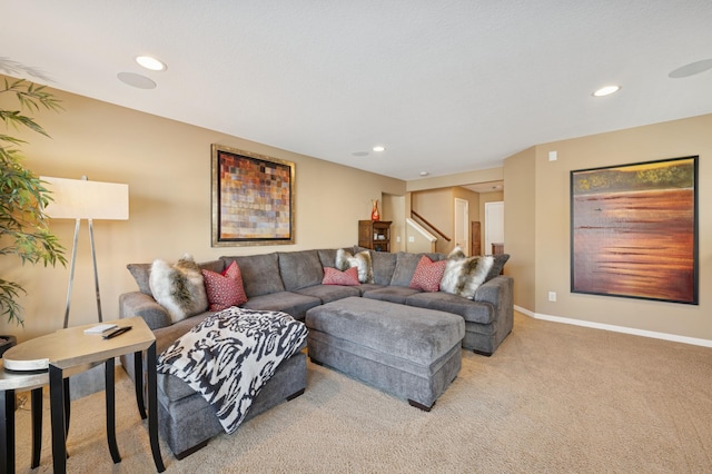 living area with stairs, recessed lighting, light colored carpet, and baseboards