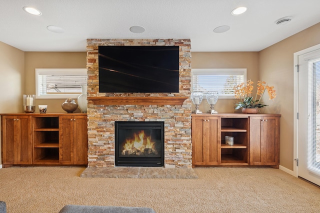 unfurnished living room featuring a fireplace, recessed lighting, carpet, and baseboards