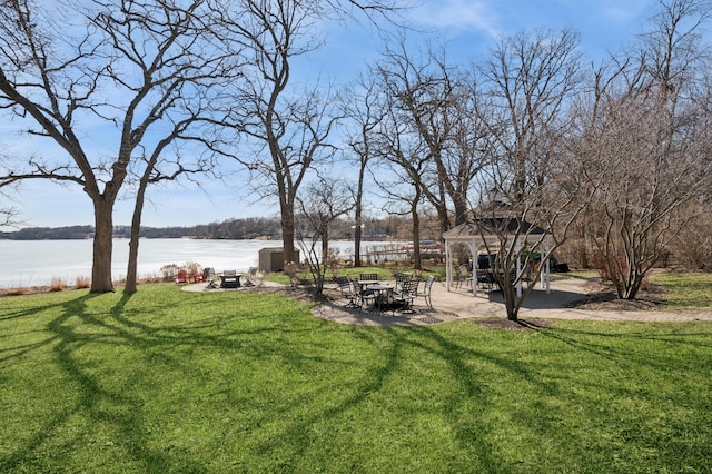 view of yard with a gazebo, a water view, and a patio area