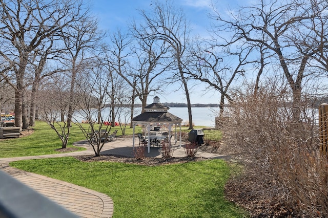 view of yard with a gazebo, a patio, and a water view