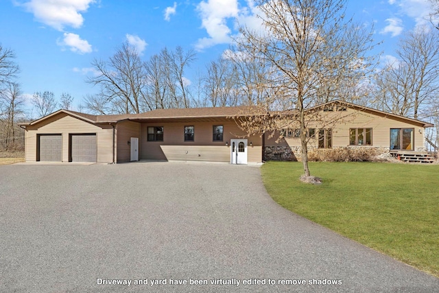 single story home featuring a shingled roof, a front lawn, a garage, and aphalt driveway