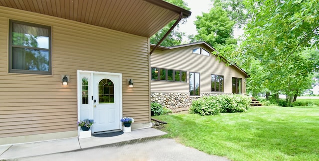 property entrance with a yard