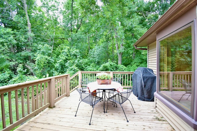 wooden terrace featuring a grill