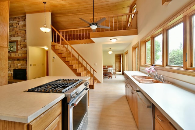 kitchen featuring wood ceiling, light countertops, appliances with stainless steel finishes, light wood-style floors, and a sink