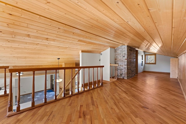 additional living space with lofted ceiling, wood finished floors, and wooden ceiling