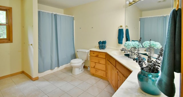 full bathroom with tile patterned flooring, curtained shower, baseboards, toilet, and vanity