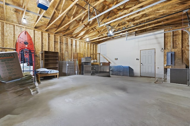 garage featuring electric panel and a garage door opener