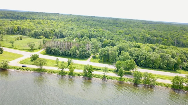 aerial view with a forest view and a water view