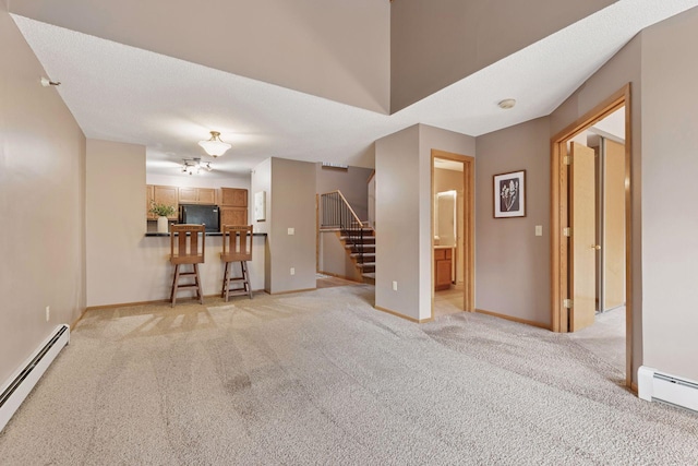 unfurnished living room featuring stairway, light colored carpet, baseboards, and a baseboard radiator