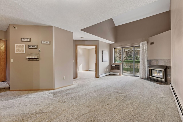 unfurnished living room with a baseboard heating unit, a tiled fireplace, carpet, and baseboards