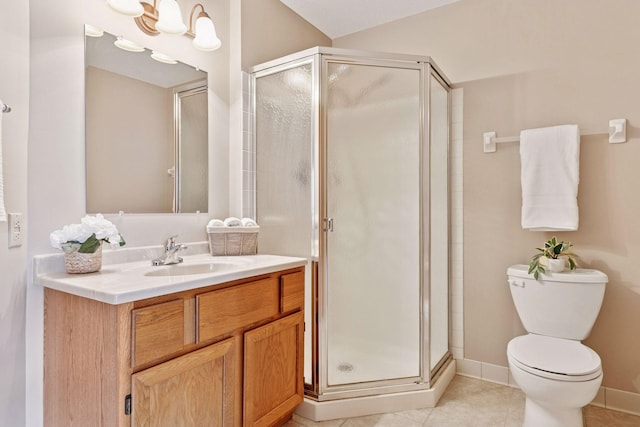 bathroom featuring tile patterned floors, toilet, a shower stall, baseboards, and vanity