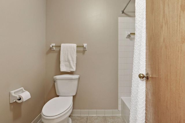 full bathroom with tile patterned floors, baseboards, and toilet