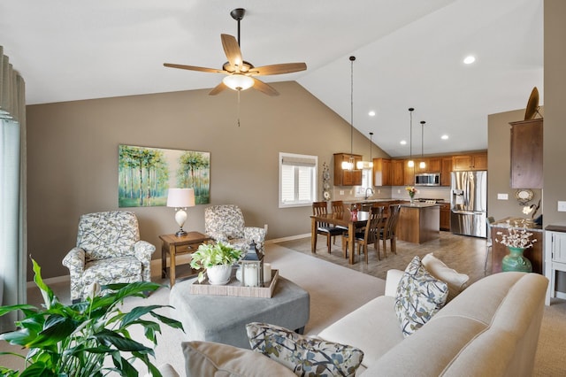 living area featuring baseboards, ceiling fan, high vaulted ceiling, and recessed lighting