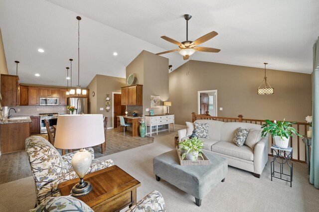 living room featuring high vaulted ceiling, recessed lighting, a ceiling fan, and light carpet