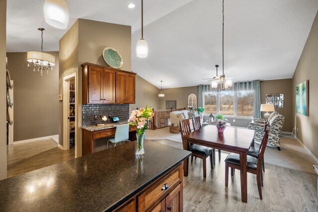 kitchen with baseboards, tasteful backsplash, light wood-type flooring, pendant lighting, and brown cabinetry