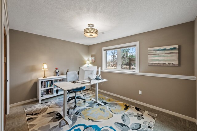 carpeted office featuring baseboards and a textured ceiling