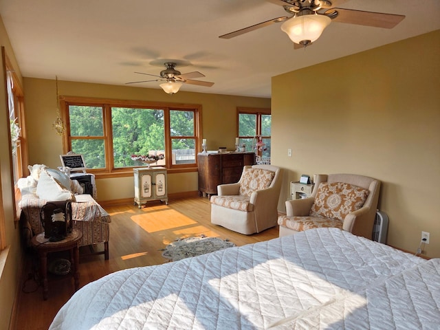 17634 240th St, Hutchinson Twp, MN 55350 - bedroom with wood finished floors, a ceiling fan, and baseboards