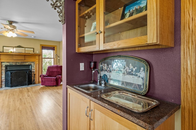 17634 240th St, Hutchinson Twp, MN 55350 - bar area with light wood finished floors, a ceiling fan, and a fireplace with raised hearth