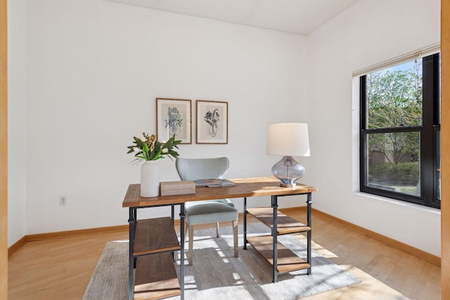 office area featuring baseboards and light wood-type flooring