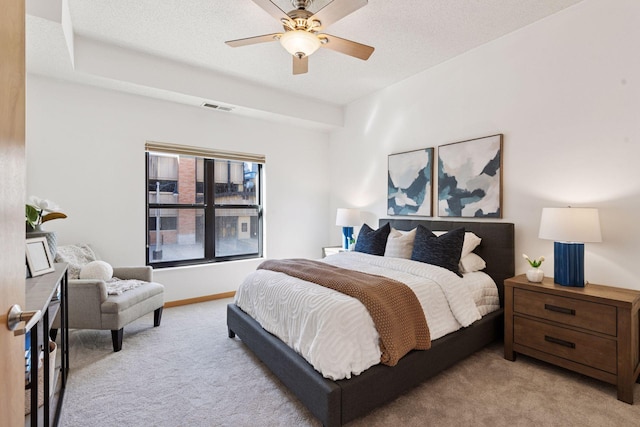 bedroom with a ceiling fan, light colored carpet, and visible vents