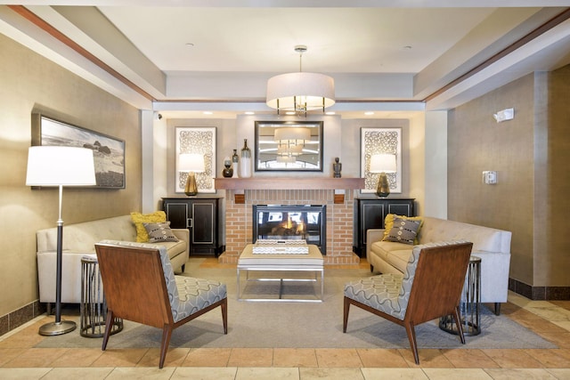 sitting room featuring light tile patterned floors, baseboards, and a brick fireplace