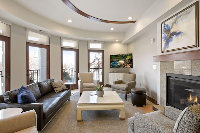 living room with recessed lighting, visible vents, and a tile fireplace