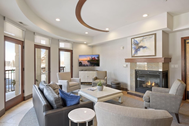 living room featuring recessed lighting, visible vents, a tiled fireplace, and light tile patterned floors