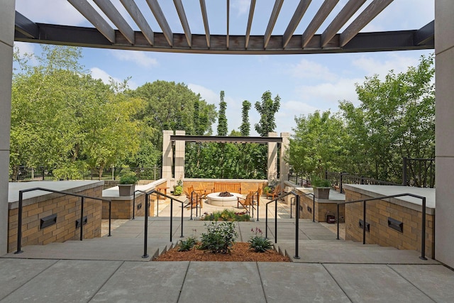 view of patio / terrace with exterior kitchen and an outdoor fire pit