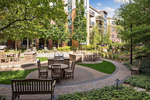view of community featuring outdoor dining area and a patio area