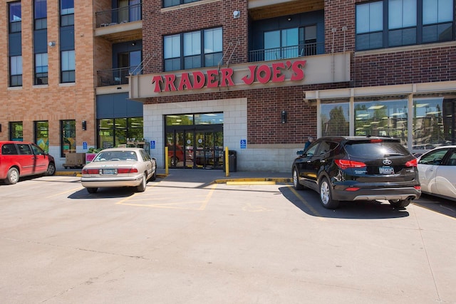 view of building exterior featuring uncovered parking