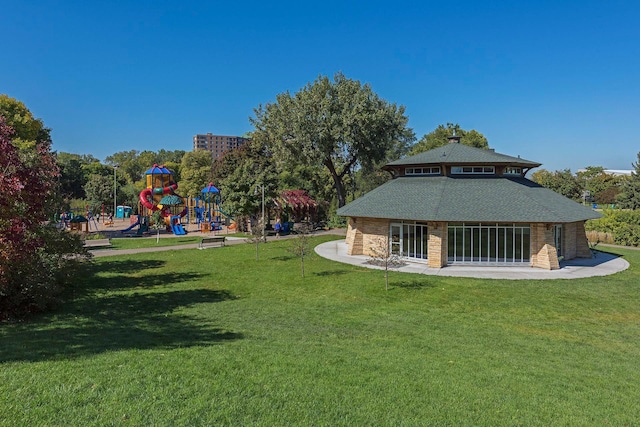 exterior space featuring a playground and a yard