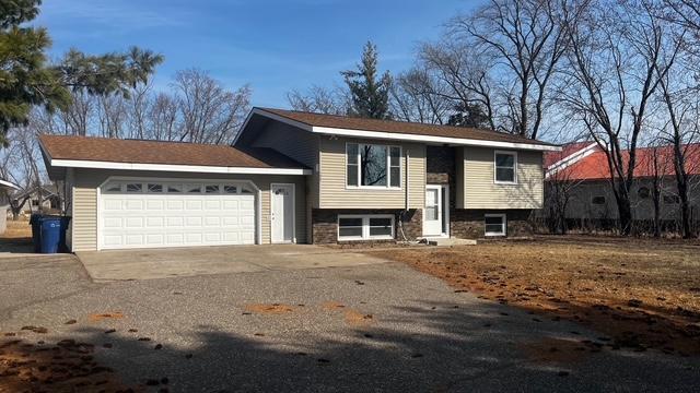 split foyer home with an attached garage and driveway