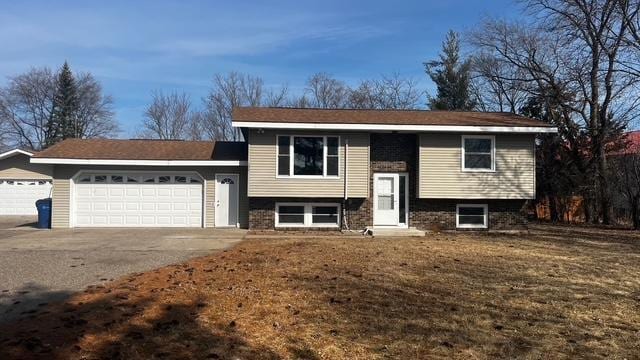 bi-level home with a garage and driveway