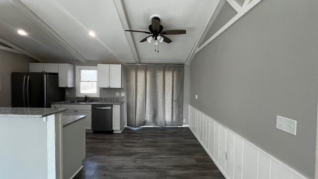 kitchen with dark wood-type flooring, ceiling fan, dishwashing machine, freestanding refrigerator, and white cabinetry