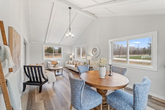 dining area with beamed ceiling, wood finished floors, baseboards, and a chandelier